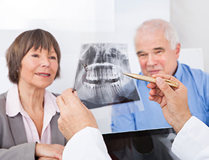 Older man and woman looking at x-rays