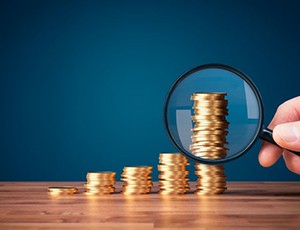 Stacks of coins examined with magnifying glass