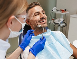 Smiling man about to have teeth examined