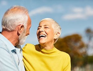 A person holding a complete denture in Herndon that exists on the lower arch of the mouth