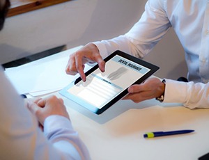 Dentist and patient reviewing a dental insurance policy