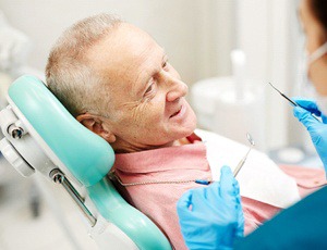 elderly man talking to his dentist
