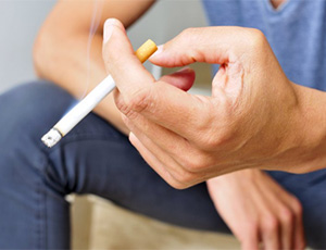 A person smoking a cigarette.