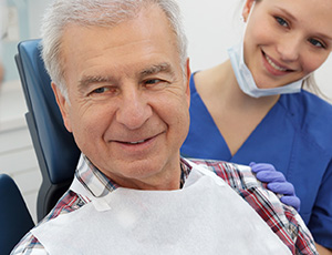 Smiling senior man in dental chair