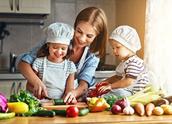 A mother and her children cutting up vegetables for a healthy meal in Herndon