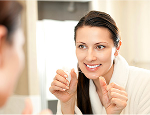 Woman flossing teeth