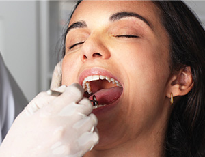 Woman receiving oral cancer screening