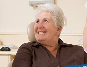 Woman in dental chair smiling