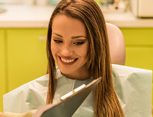 Dentist showing a chart to a woman in a dental chair