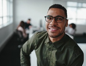 person smiling and sitting down at work