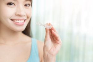 Young woman holding Invisalign
