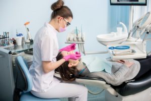 dentist cleaning patient's teeth