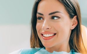 a patient smiling while visiting their cosmetic dentist in Herndon