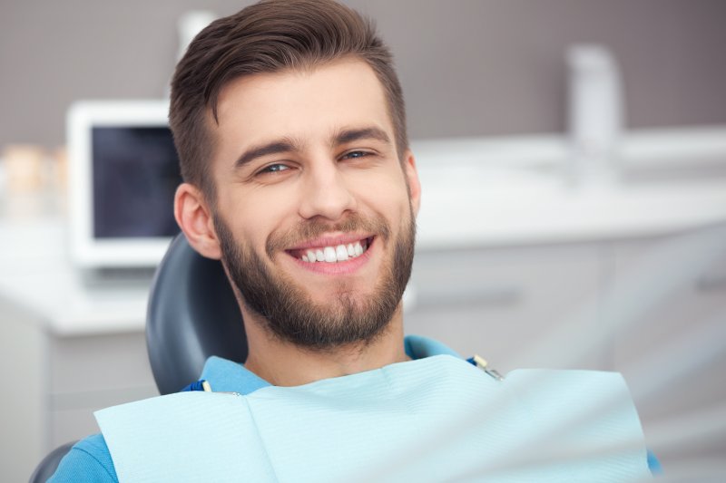 person smiling after being treated by cosmetic dentist