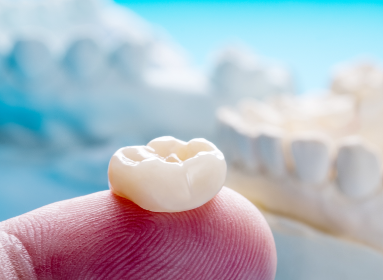 Dental crown on fingertip